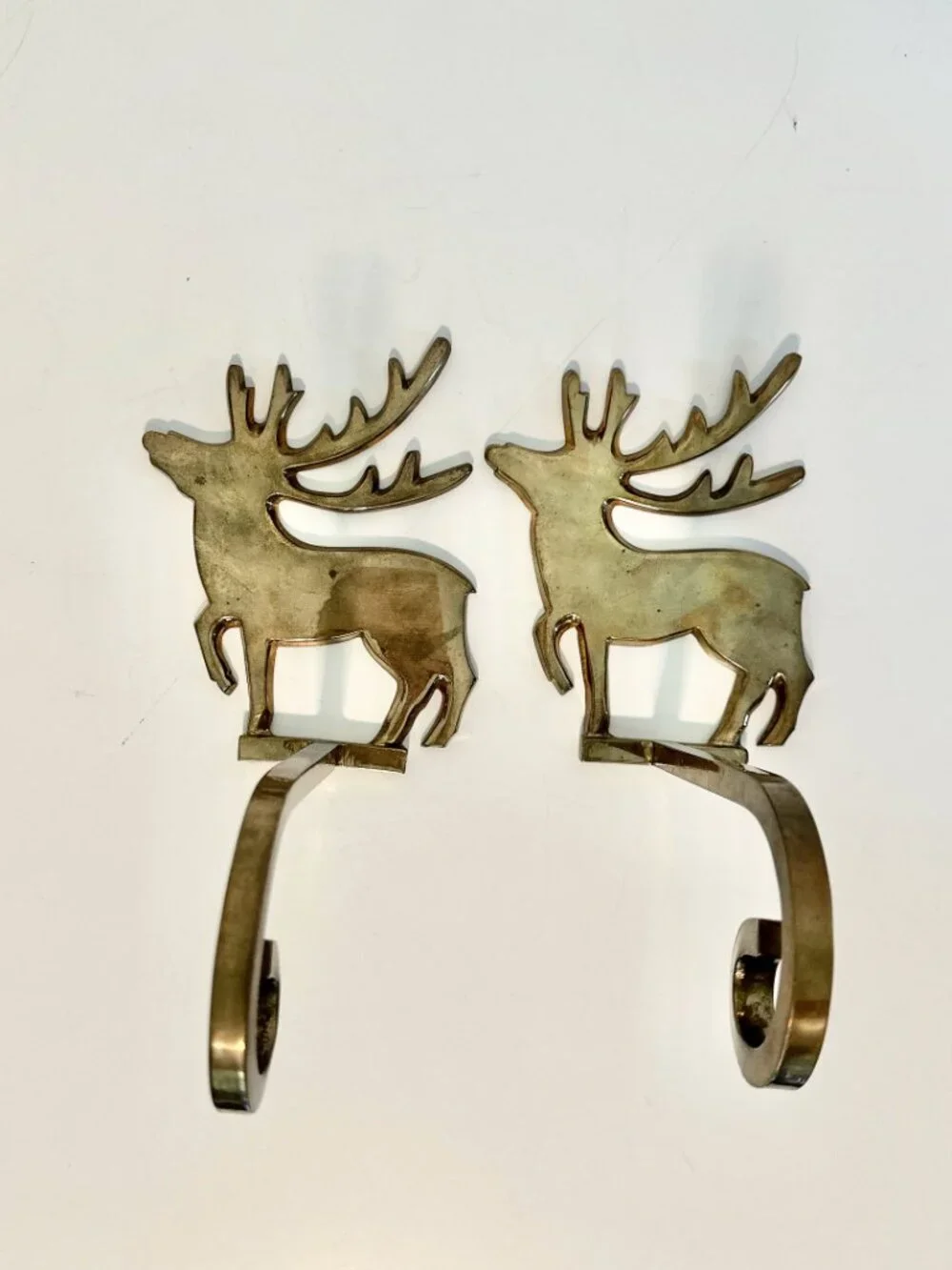 SET OF FOUR BRASS REINDEER MANTEL STOCKING HANGERS